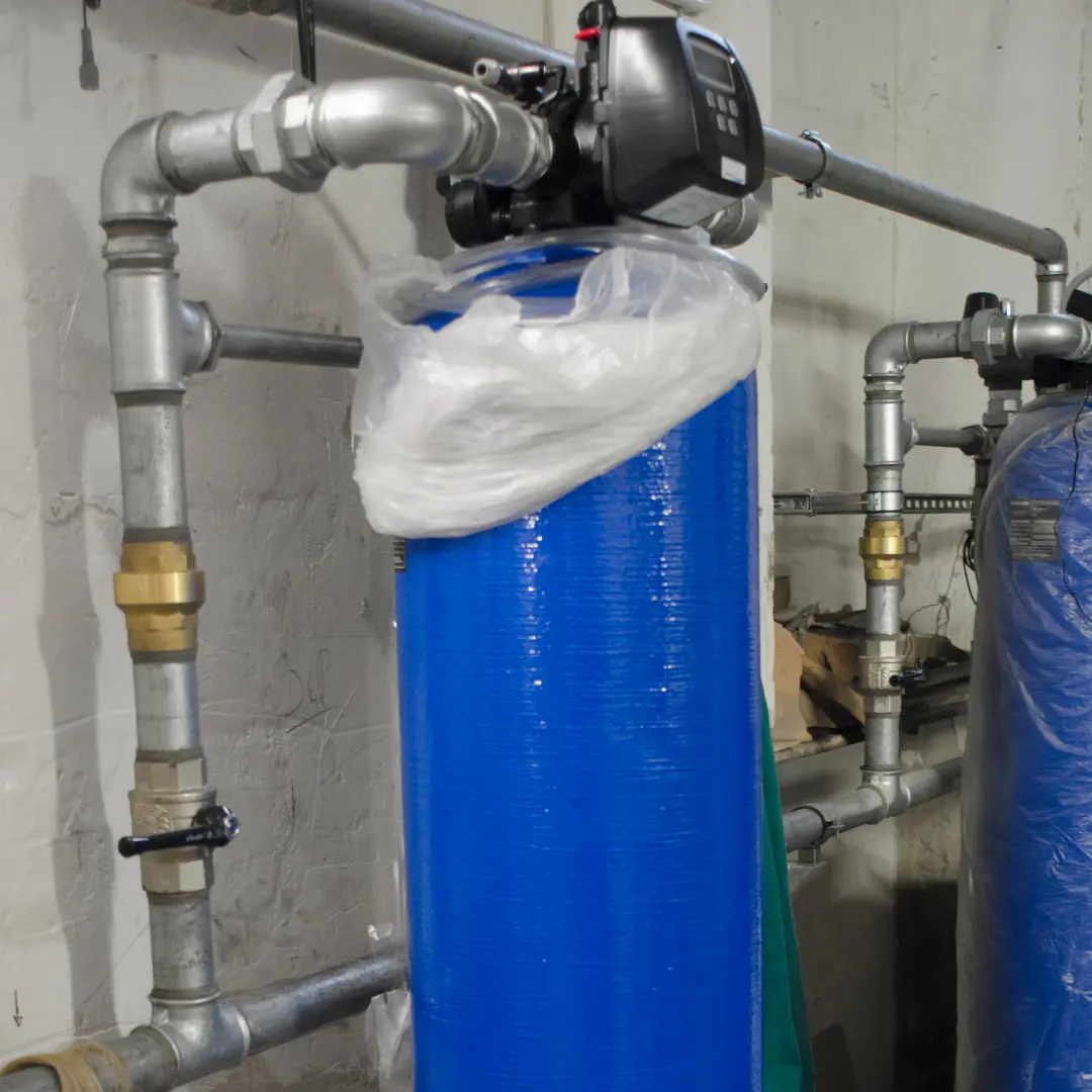 HVAC and plumbing Patterson NY, well water treatment tank and plumbing in a home utility room